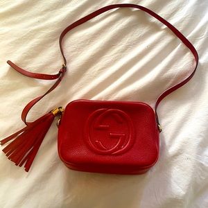 Red gucci leather crossbody bag with tassle.